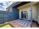 Enclosed backyard patio with artificial grass, brick trim, and sliding glass door to indoor space at 7801 N 44Th Dr # 1003, Glendale, AZ 85301