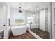 Beautiful bathroom featuring a standalone tub, glass enclosed shower, and elegant fixtures at 7802 N 6Th St, Phoenix, AZ 85020