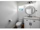 Bright bathroom features modern vanity, round mirror, and neutral finishes, creating a clean, contemporary look at 7802 N 6Th St, Phoenix, AZ 85020
