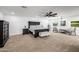 Expansive main bedroom with neutral carpet, ceiling fan, and abundant natural light from multiple windows at 7802 N 6Th St, Phoenix, AZ 85020