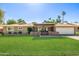 Charming single-story home with a well-manicured lawn and a covered front patio at 7802 N 6Th St, Phoenix, AZ 85020