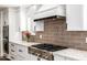 Close-up of stainless steel gas range and gray subway tile backsplash in the kitchen at 7802 N 6Th St, Phoenix, AZ 85020