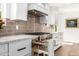 Pull out storage beside range and gray subway tile backsplash enhances this modern kitchen at 7802 N 6Th St, Phoenix, AZ 85020