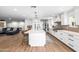 Open-concept kitchen with center island, modern appliances, and seamless flow to living area at 7802 N 6Th St, Phoenix, AZ 85020