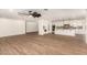 Bright living room featuring tile floors that flow into an open kitchen space with white cabinetry and a center island at 7802 N 6Th St, Phoenix, AZ 85020