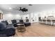 Bright, open living space with wood-look tile floors, comfortable seating, and seamless flow to dining and kitchen areas at 7802 N 6Th St, Phoenix, AZ 85020
