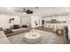Open living room with tile floors seamlessly connects to a modern kitchen with white cabinets and island seating at 7802 N 6Th St, Phoenix, AZ 85020