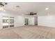 Large open living space featuring neutral carpet, access to a backyard pool, and minimalist decor at 7802 N 6Th St, Phoenix, AZ 85020