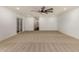 Spacious living room features a ceiling fan, neutral carpet, and access to outdoor space at 7802 N 6Th St, Phoenix, AZ 85020