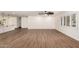Spacious living room with tile floors, white walls, and shuttered windows overlooking outdoor scenery at 7802 N 6Th St, Phoenix, AZ 85020