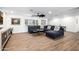 Spacious living room with wood-look tile flooring, dark blue sectional sofa, and recessed lighting at 7802 N 6Th St, Phoenix, AZ 85020