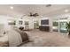 Spacious main bedroom with carpet, neutral decor, and glass doors leading to a refreshing pool area at 7802 N 6Th St, Phoenix, AZ 85020