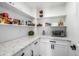 Well-organized pantry with white shelving, granite counters, and ample storage space for dry goods and kitchen appliances at 7802 N 6Th St, Phoenix, AZ 85020