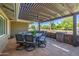 Relaxing covered patio with outdoor dining set and brick accents at 7802 N 6Th St, Phoenix, AZ 85020