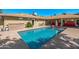 Lush backyard showcasing a pristine pool with surrounding patio space and outdoor seating areas at 7802 N 6Th St, Phoenix, AZ 85020