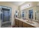 Bathroom featuring dual sinks, ample cabinet space, and walk-in shower at 8160 E Keats Ave # 364, Mesa, AZ 85209