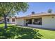 Single-story property featuring a well-maintained lawn and inviting patio area with table and chairs at 8160 E Keats Ave # 364, Mesa, AZ 85209