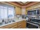 Corner kitchen featuring stainless steel appliances and wood cabinets at 8160 E Keats Ave # 364, Mesa, AZ 85209