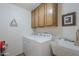 Functional laundry room equipped with washer, dryer, sink, and storage cabinets at 8160 E Keats Ave # 364, Mesa, AZ 85209