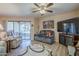 Comfortable living room with sliding doors to the patio, ceiling fan, and entertainment center at 8160 E Keats Ave # 364, Mesa, AZ 85209
