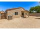 Home exterior view showing a covered patio and gravel backyard with desert landscaping at 8321 W Hughes Dr, Tolleson, AZ 85353