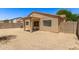 An expansive backyard with gravel landscaping and a covered patio at 8321 W Hughes Dr, Tolleson, AZ 85353