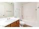 Bright bathroom with a single sink vanity, toilet, shower and tub combination at 8321 W Hughes Dr, Tolleson, AZ 85353