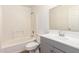 Bathroom with tiled shower, modern vanity, and fixtures at 8321 W Hughes Dr, Tolleson, AZ 85353