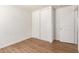 Bedroom with hardwood floors, a closet with sliding doors and white trim at 8321 W Hughes Dr, Tolleson, AZ 85353