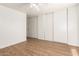 Bedroom with wood floors, ample closet space, and natural light at 8321 W Hughes Dr, Tolleson, AZ 85353