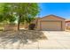 Charming single-story home featuring a two-car garage and a well-maintained front yard with desert landscaping at 8321 W Hughes Dr, Tolleson, AZ 85353