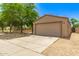 The property features a two-car garage with a spacious driveway and low maintenance desert landscaping at 8321 W Hughes Dr, Tolleson, AZ 85353