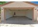 Spacious two car garage interior with access door and mechanicals at 8321 W Hughes Dr, Tolleson, AZ 85353