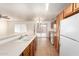 Bright kitchen featuring wood cabinets, and stainless appliances, with a view of the outdoor patio at 8321 W Hughes Dr, Tolleson, AZ 85353