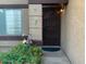 Inviting front entryway with decorative hummingbirds, secure door, and lush flower garden at 8338 W Coolidge St, Phoenix, AZ 85037