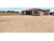 Rear view of the house showcasing a large backyard and covered patio at 8350 W Carole Ln, Glendale, AZ 85305