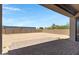 Expansive backyard with a large paved patio, surrounded by block fencing at 8350 W Carole Ln, Glendale, AZ 85305