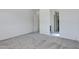 Spacious bedroom featuring neutral carpet and doorway to bathroom at 8350 W Carole Ln, Glendale, AZ 85305