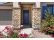 Home's entryway featuring stone accents on the columns and a security system for added protection at 8350 W Carole Ln, Glendale, AZ 85305