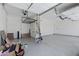 A clean, spacious two-car garage with epoxy flooring and overhead storage racks at 8350 W Carole Ln, Glendale, AZ 85305