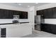 Open-concept kitchen featuring a large center island, dark cabinetry, and stainless steel appliances at 8350 W Carole Ln, Glendale, AZ 85305