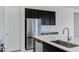 Contemporary kitchen showcasing stainless steel refrigerator, ample storage, and sleek white countertops at 8350 W Carole Ln, Glendale, AZ 85305