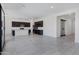 Bright open floor plan kitchen with dark cabinets, white backsplash, and island at 8350 W Carole Ln, Glendale, AZ 85305