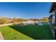 Expansive backyard featuring artificial turf, swimming pool, and outdoor kitchen at 8366 E Old Paint Trl # 3, Scottsdale, AZ 85266