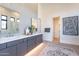 Bathroom featuring double vanity with stylish mirrors, tiled walls, glass-enclosed shower, and an inviting open space at 8366 E Old Paint Trl # 3, Scottsdale, AZ 85266