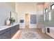 Modern bathroom boasting a luxurious soaking tub, glass-enclosed shower, and stylish vanity with double sinks at 8366 E Old Paint Trl # 3, Scottsdale, AZ 85266