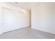 Bright bedroom with sliding closet doors, light tiled floors, and white walls at 8366 E Old Paint Trl # 3, Scottsdale, AZ 85266