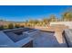 Backyard firepit with ample bench seating and desert landscaping at 8366 E Old Paint Trl # 3, Scottsdale, AZ 85266