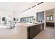Spacious open-concept kitchen with a waterfall island, sleek cabinets, and modern fixtures at 8366 E Old Paint Trl # 3, Scottsdale, AZ 85266