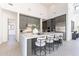 Modern kitchen with barstool seating at the waterfall island and sleek gray cabinets at 8366 E Old Paint Trl # 3, Scottsdale, AZ 85266